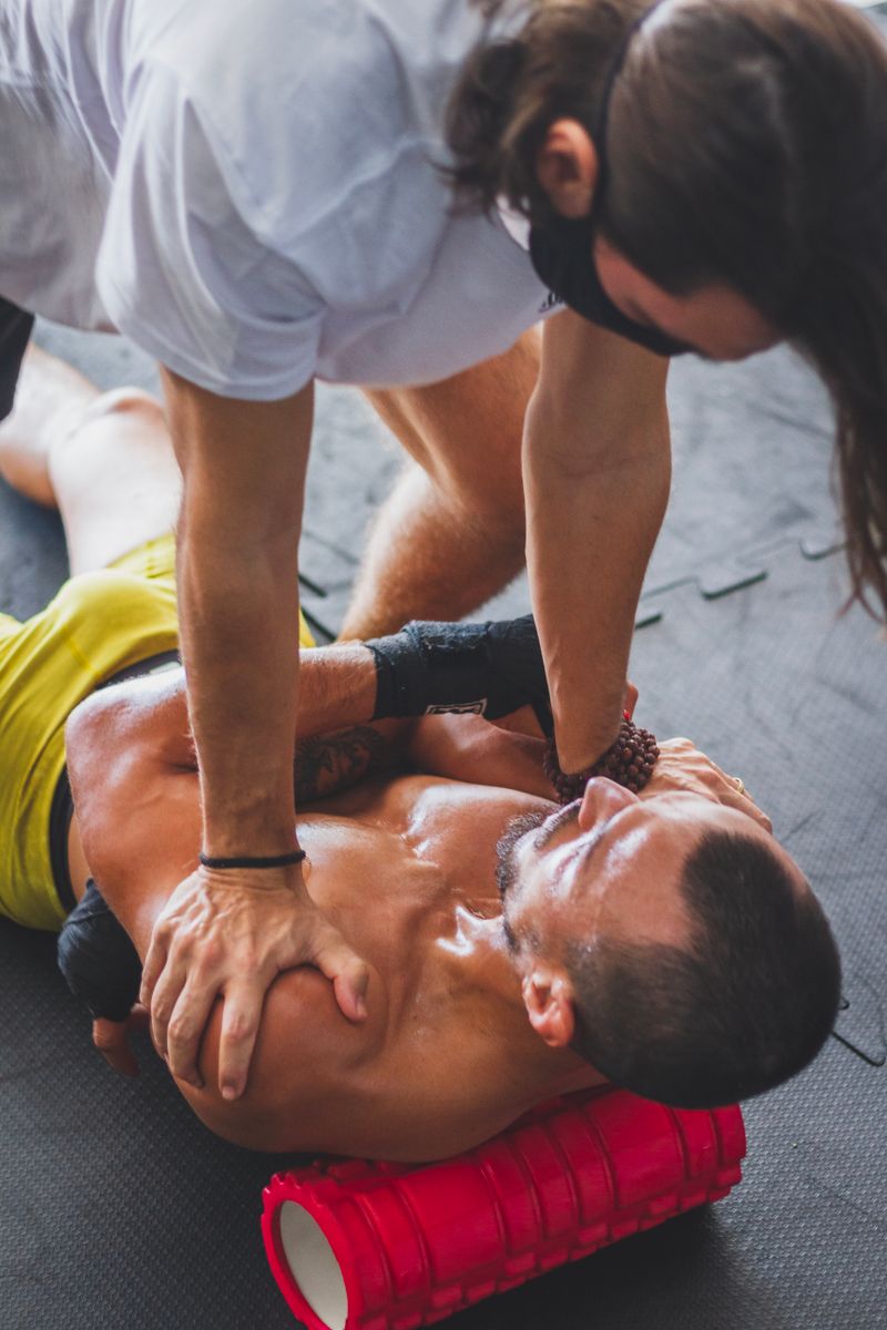 Athlete receiving foam roller therapy for muscle recovery