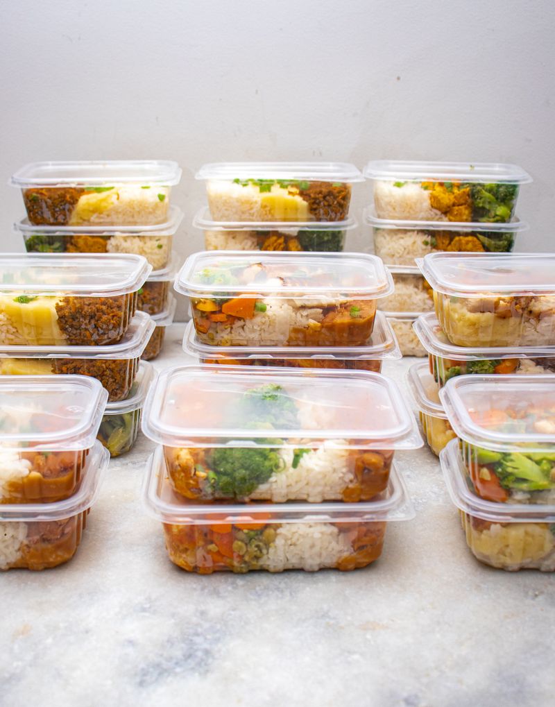 Organized meal prep containers with rice and vegetables