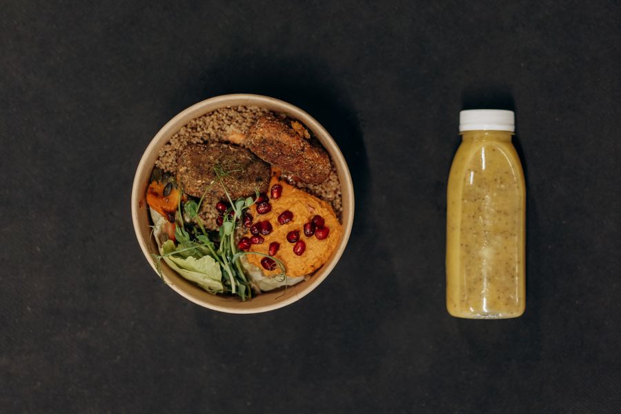Vegan bowl with quinoa, vegetables, and a smoothie