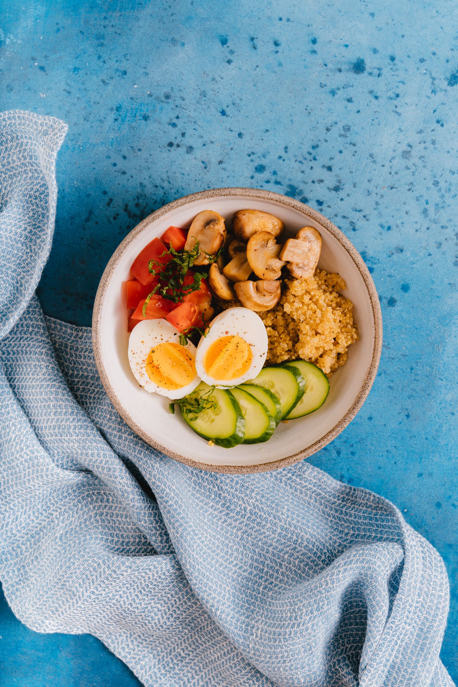 Vibrant bowl with quinoa, eggs, and fresh vegetables